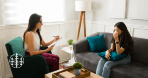 Person crying in a therapist’s office during an Accelerated Resolution Therapy session, representing the process to get rid of trauma quickly and safely.