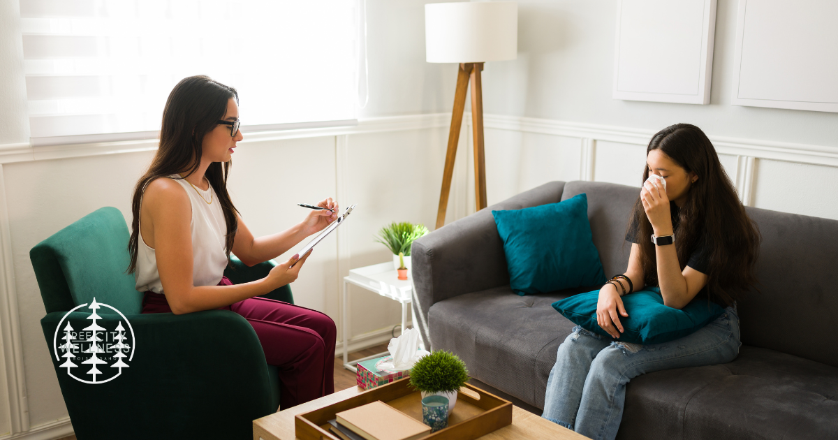 Person crying in a therapist’s office during an Accelerated Resolution Therapy session, representing the process to get rid of trauma quickly and safely.
