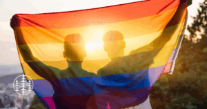 LGBTQIAs2 affirming therapy in Idaho. Gay couple with rainbow flag celebrating
